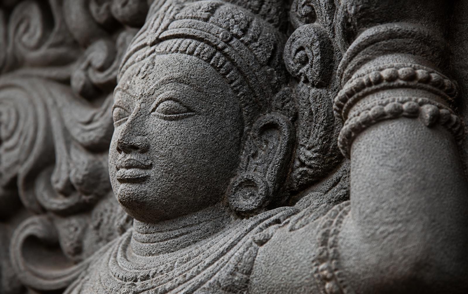Close-up of a hand-carved granite relief panel